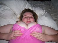 Fat Amateur Lady Laying Down Holding Tits - plump woman with large juggy