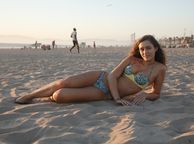 Young Brunette Woman In Her Bikini Laying On The Sand - girl non nude